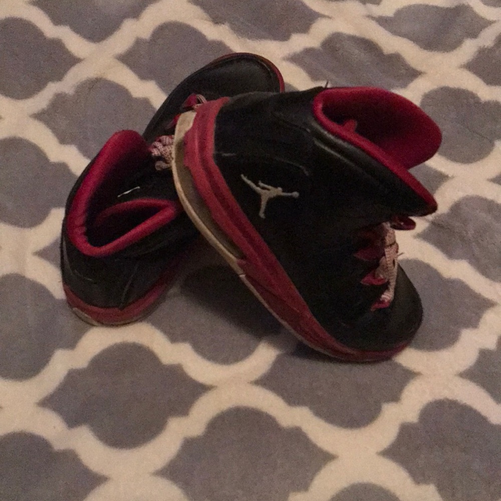 fuchsia pink and black Jordan’s